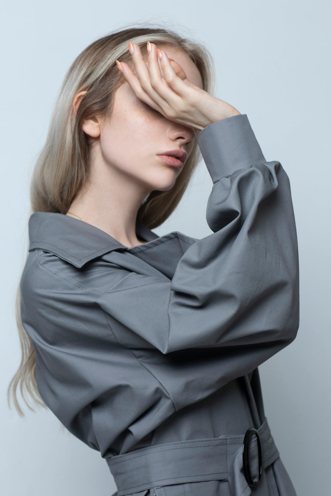 woman in black long sleeve shirt covering her face