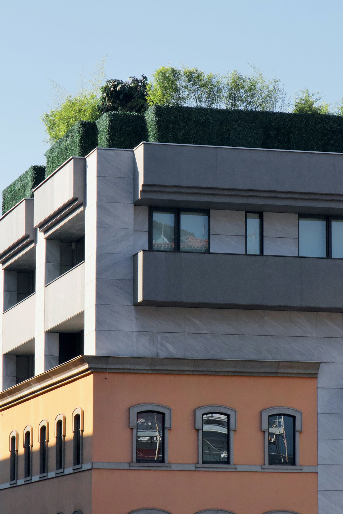 a tall building with a green roof on top of it