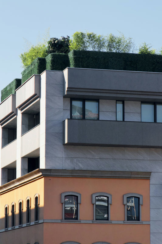 a tall building with a green roof on top of it