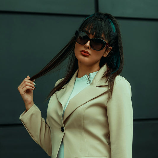 a woman wearing sunglasses and a beige coat