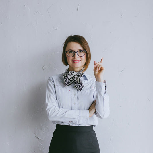 a woman wearing glasses and a bow tie