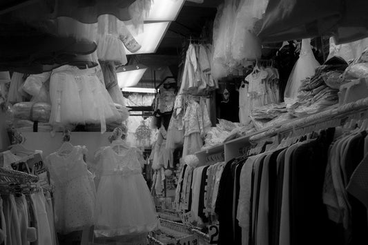 Rows of white dresses hanging on display