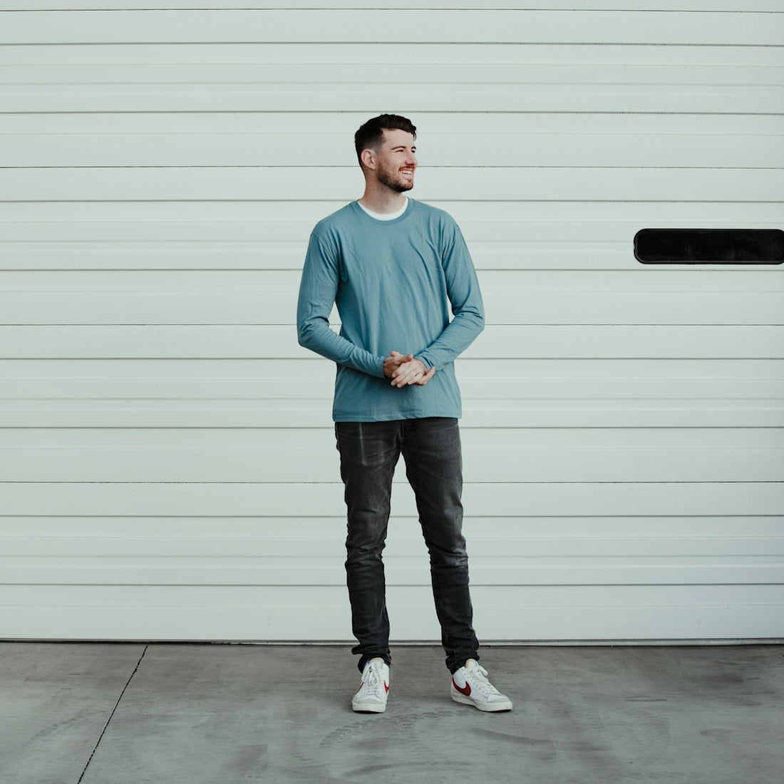 a man standing in front of a garage door