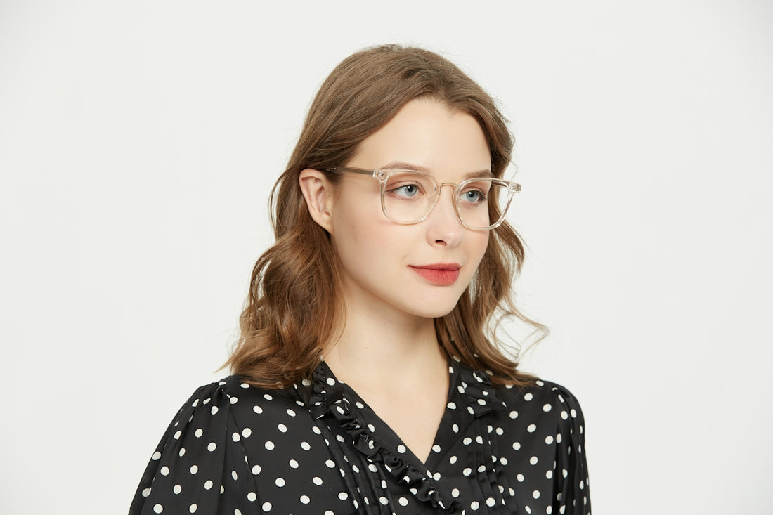 A woman wearing glasses and a polka dot shirt