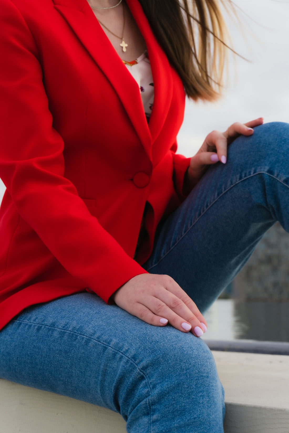 Woman in red blazer and blue jeans
